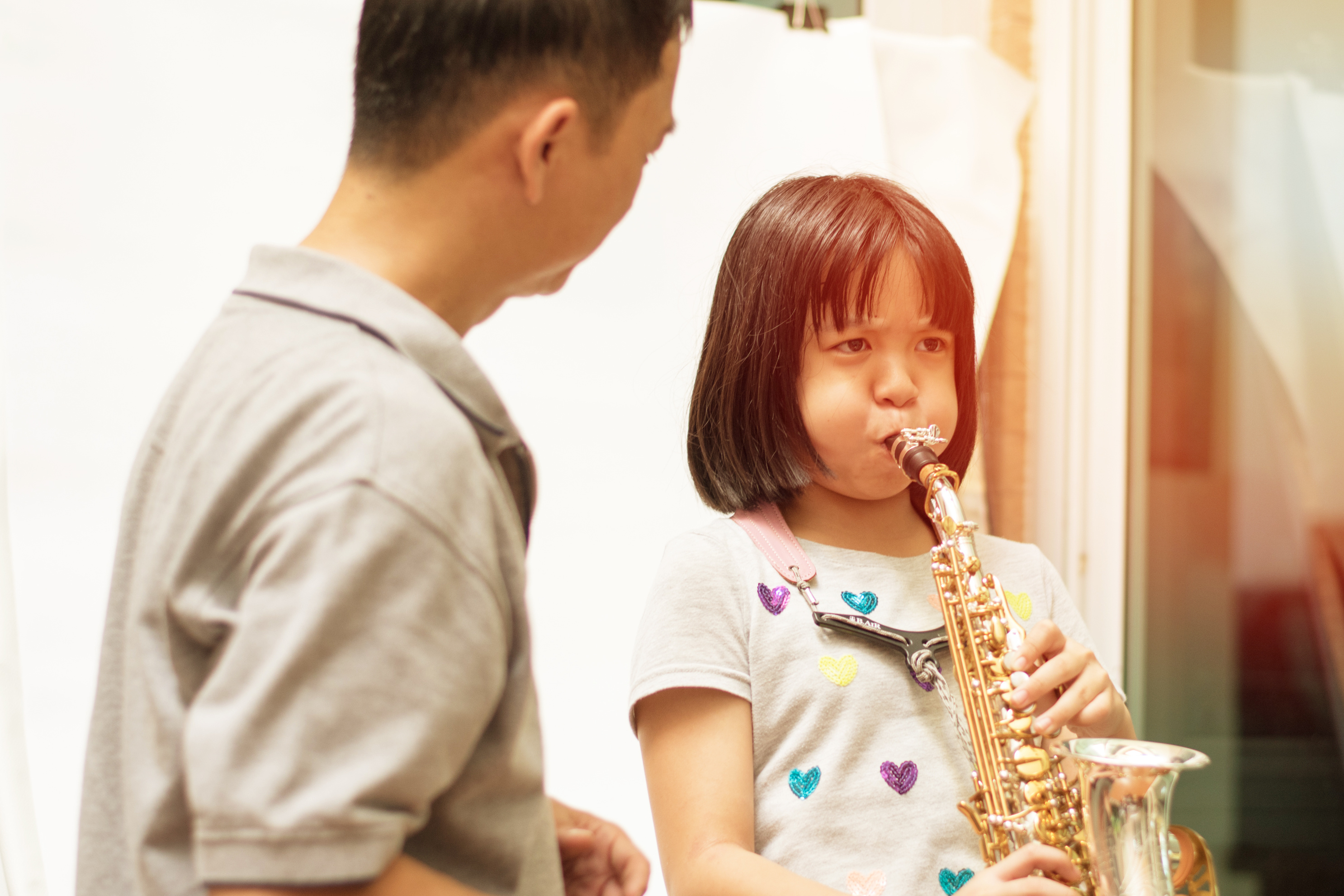 Girl Practicing Sax with Dad