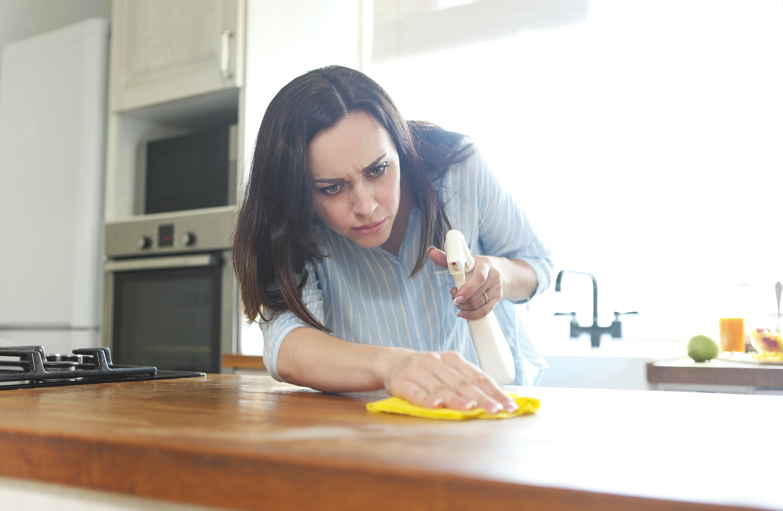 Woman Disinfecting Counter